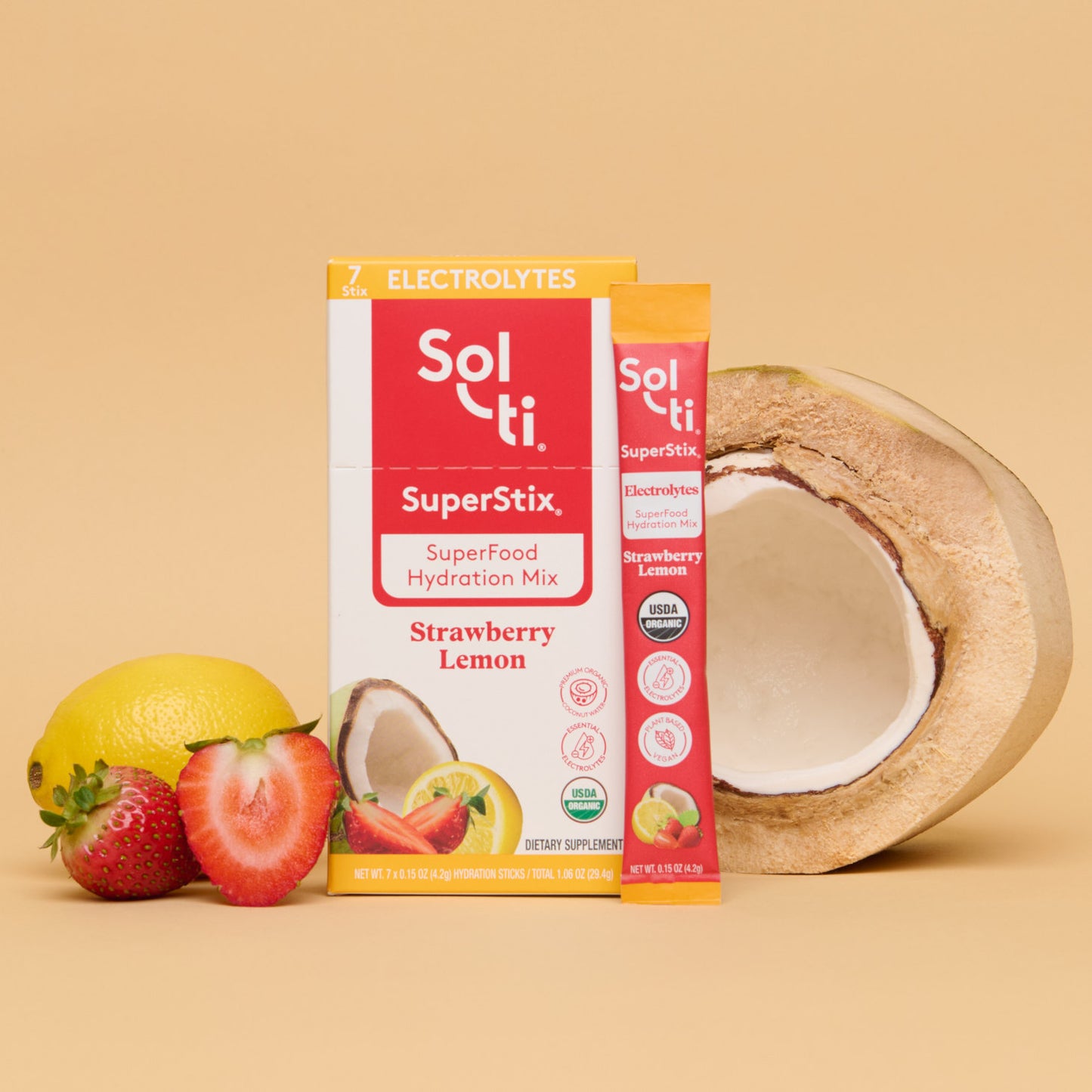 Sol-ti SuperStix Strawberry Lemon box front with stick angled on beige background, with coconut, lemon, and strawberries
