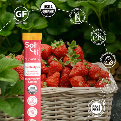 Strawberry Lemon SuperStix pack with front label on strawberries background, with logo benefits: Gluten Free, USDA Organic, no added sodium, no cane sugar, sustainable packaging, Ocean minerals and Lab tested No forever Chemicals or microplastics