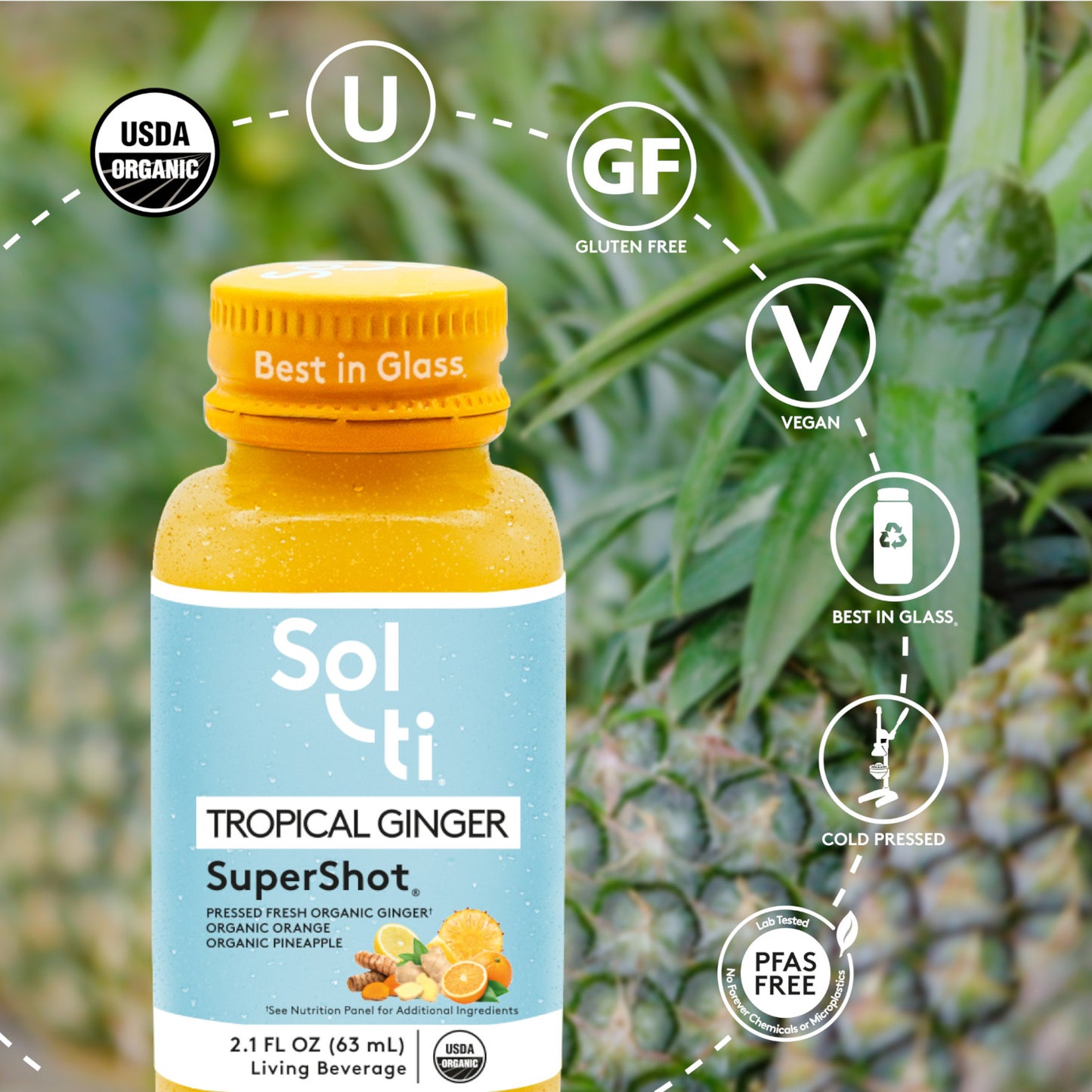 TROPICAL GINGER SuperShot bottle with front label on pineapples background, showing pineapple, ginger and turmeric roots, with logo benefits: USDA Organic, kosher, Gluten Free, Vegan, Best in Glass, Cold pressed and Lab tested No forever Chemicals or microplastics